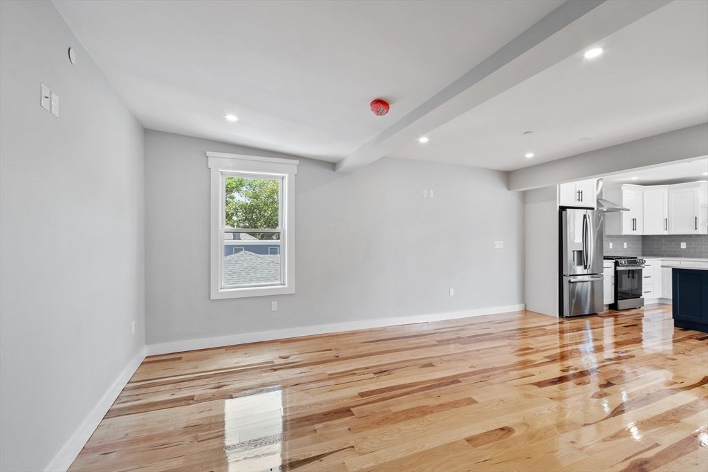 Empty room, Interior, Kitchen, Recessed Lighting, Stainless Steel Appliances, Wood Texture Flooring