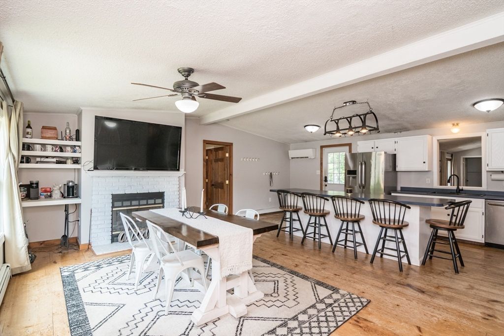 Dining room, Fireplace, Interior, Kitchen, Stainless Steel Appliances, Wood Texture Flooring