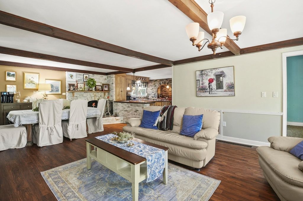 Chandelier, Dining room, Fireplace, Interior, Living room, Pendant Lights, Stone Walls, Wooden Beams, Wood Texture Flooring