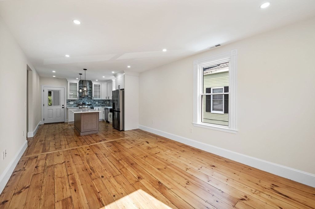 Empty room, Interior, Kitchen, Pendant Lights, Recessed Lighting, Stainless Steel Appliances, Wood Texture Flooring
