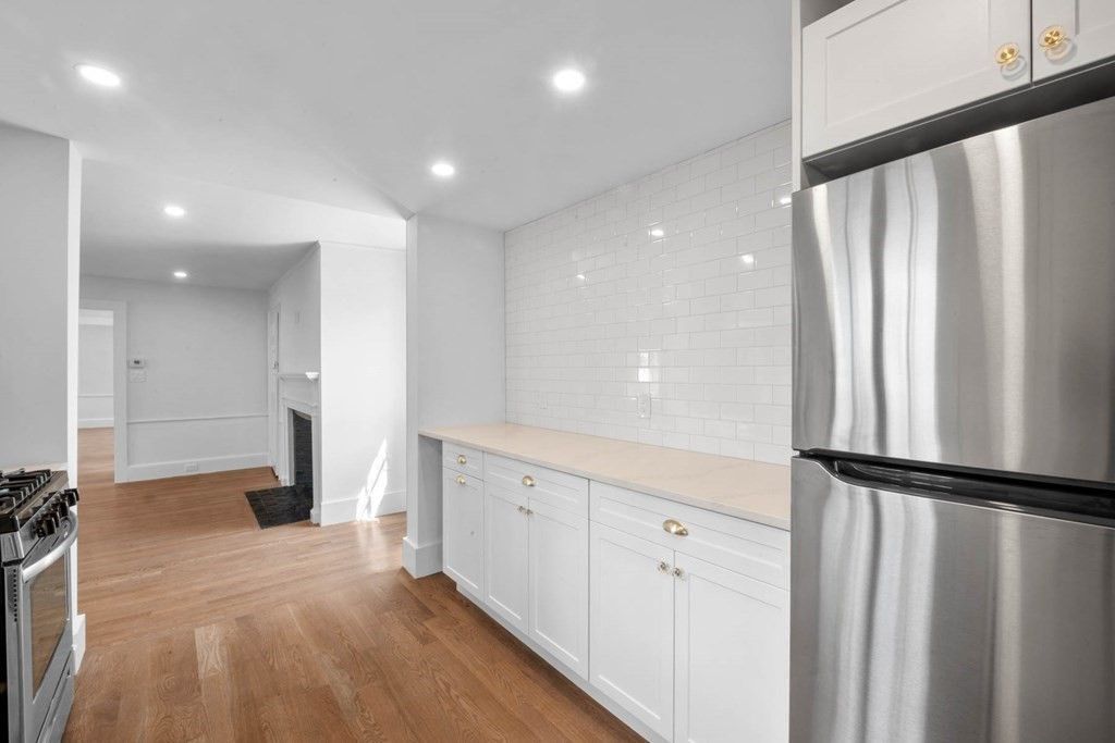 Fireplace, Interior, Kitchen, Recessed Lighting, Stainless Steel Appliances, Wood Texture Flooring