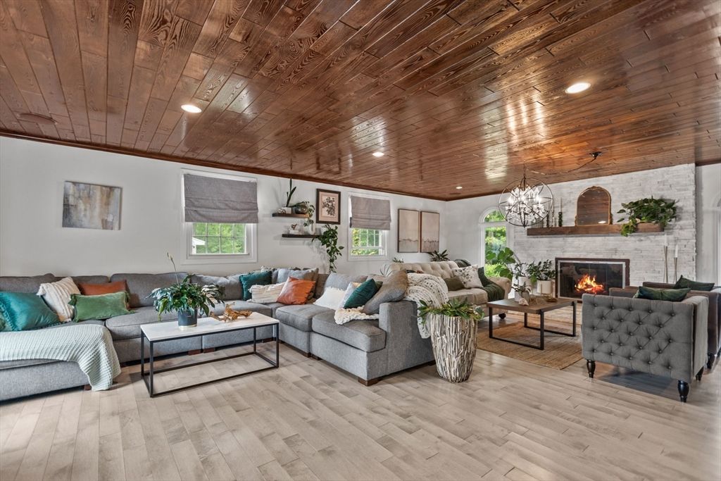 Chandelier, Fireplace, Interior, Living room, Recessed Lighting, Stone Walls, Wooden Ceilings, Wood Texture Flooring