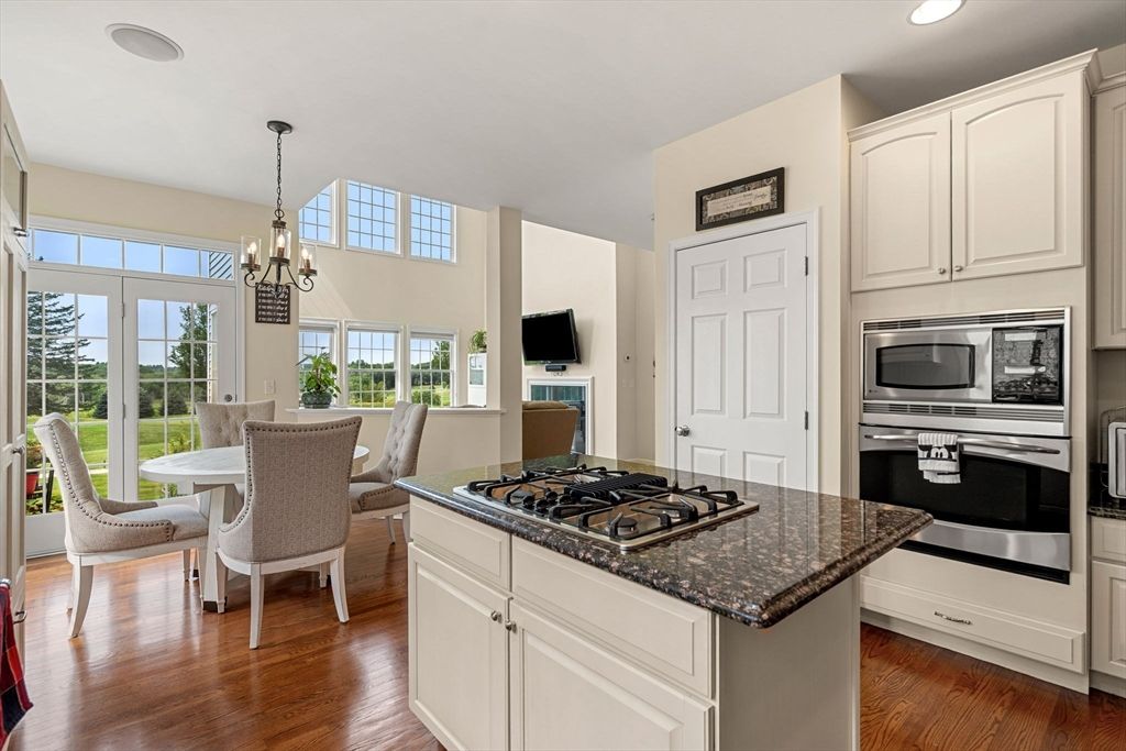 Chandelier, Dining room, Interior, Kitchen, Pendant Lights, Recessed Lighting, Stainless Steel Appliances, Wood Texture Flooring