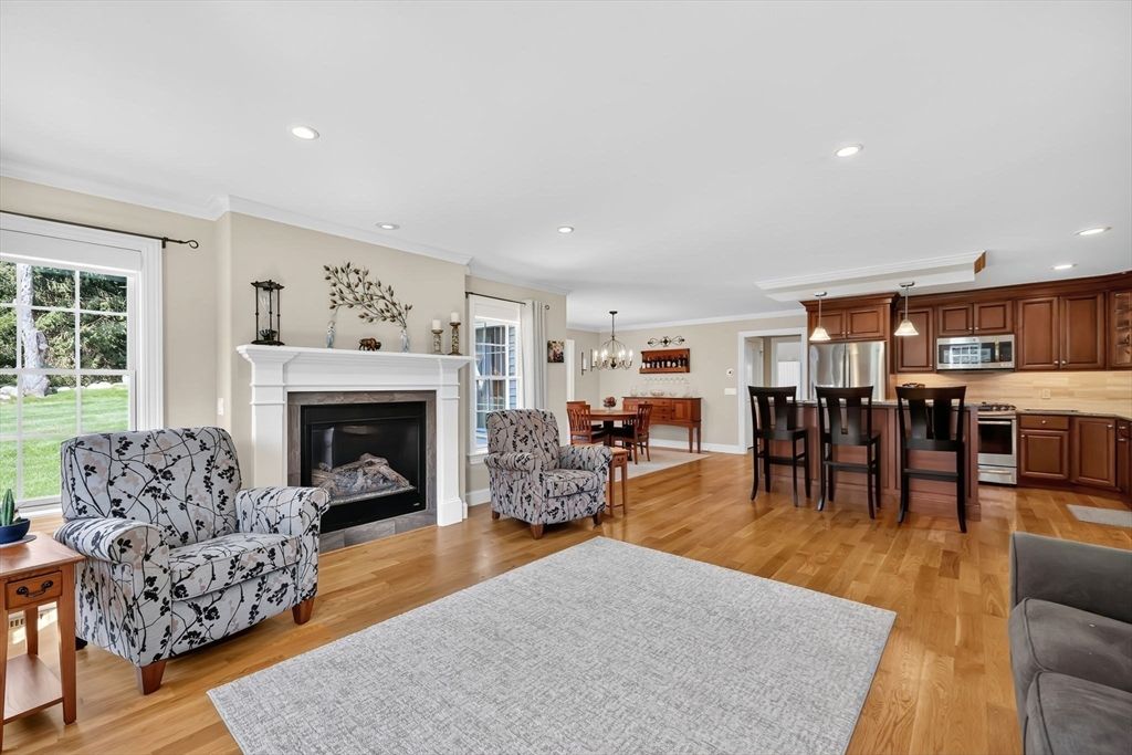 Chandelier, Dining room, Fireplace, Interior, Kitchen, Living room, Pendant Lights, Recessed Lighting, Stainless Steel Appliances, Wood Texture Flooring