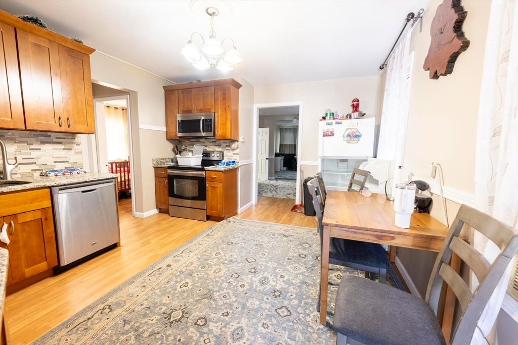 Chandelier, Dining room, Interior, Kitchen, Stainless Steel Appliances, Wood Texture Flooring