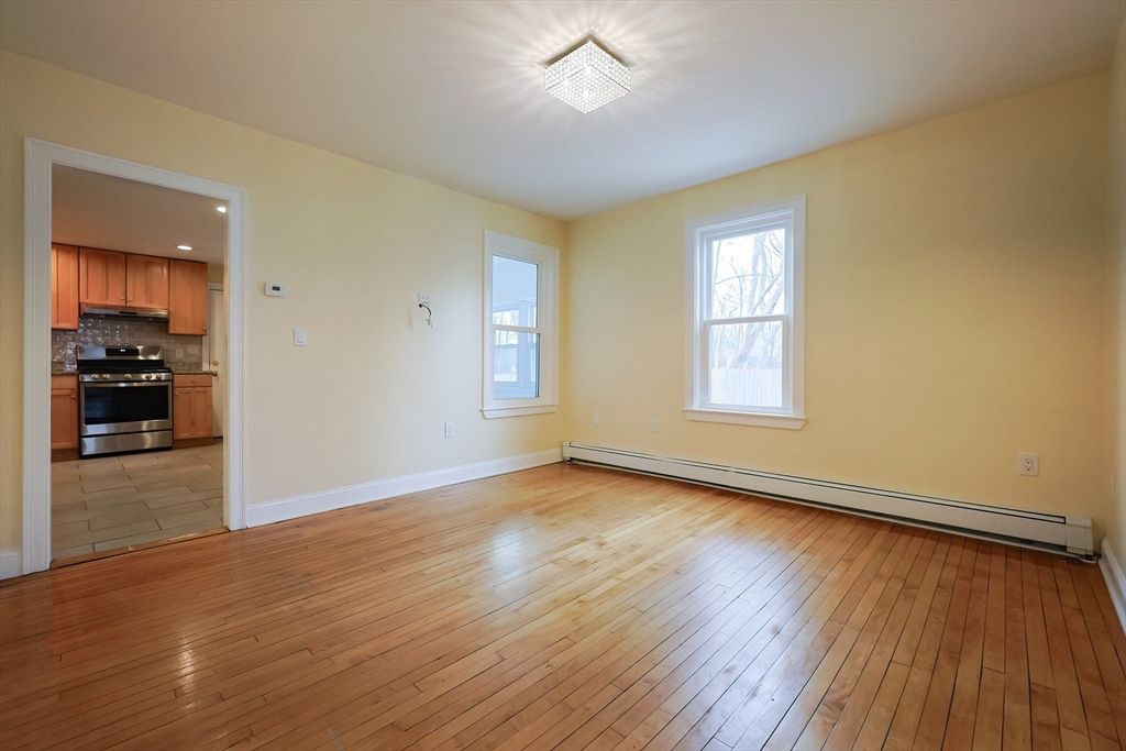 Empty room, Interior, Kitchen, Recessed Lighting, Stainless Steel Appliances, Wood Texture Flooring
