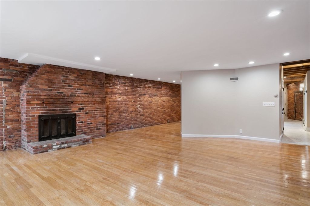 Empty room, Fireplace, Interior, Recessed Lighting, Stone Walls, Wood Texture Flooring