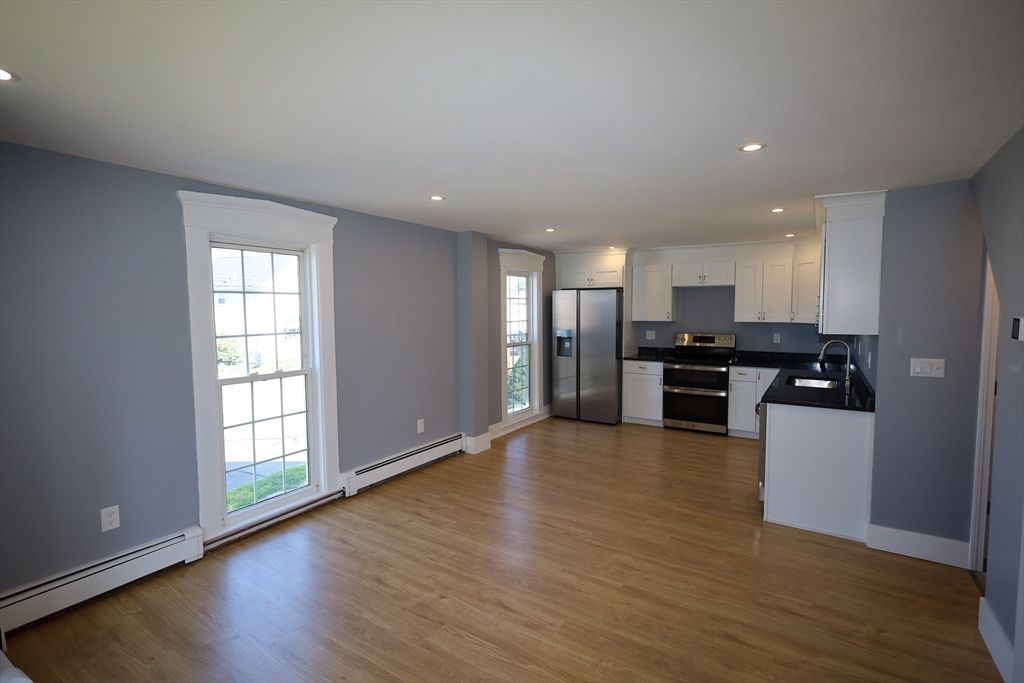Empty room, Interior, Kitchen, Recessed Lighting, Stainless Steel Appliances, Wood Texture Flooring