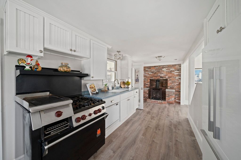 Fireplace, Interior, Kitchen, Stainless Steel Appliances, Stone Walls, Wood Texture Flooring