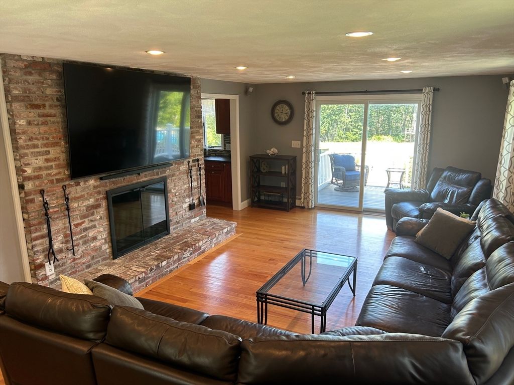 Fireplace, Interior, Living room, Recessed Lighting, Stone Walls, Wood Texture Flooring