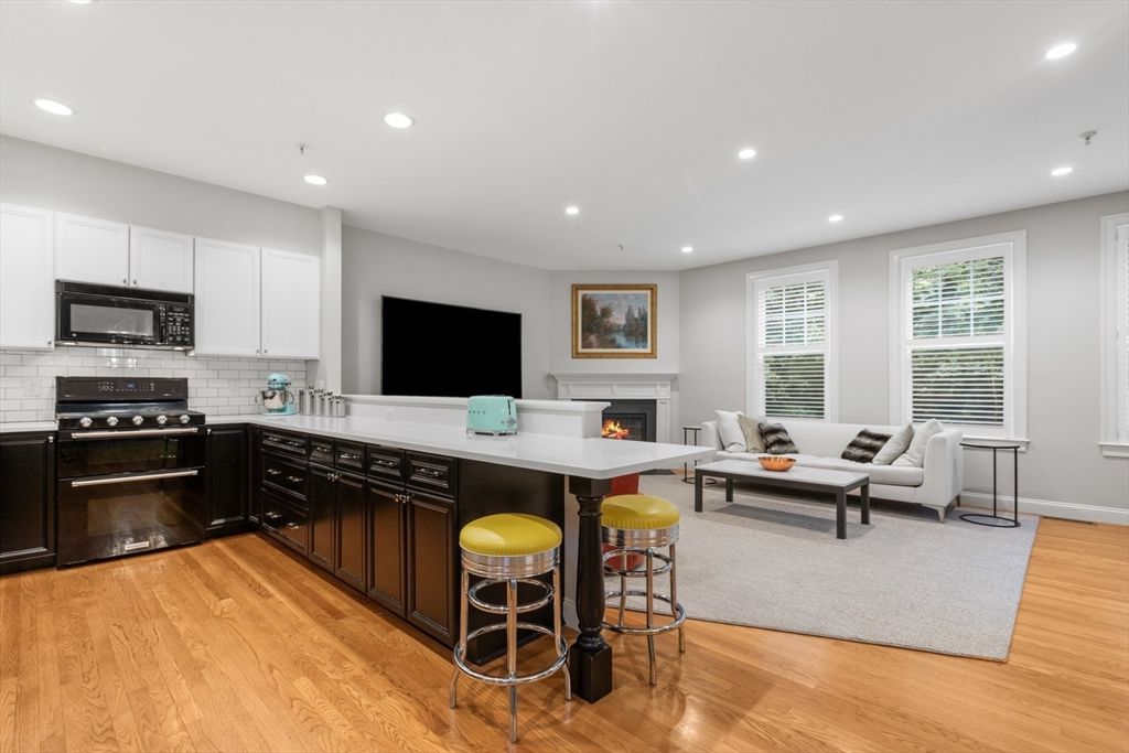 Fireplace, Interior, Kitchen, Living room, Recessed Lighting, Stainless Steel Appliances, Wood Texture Flooring