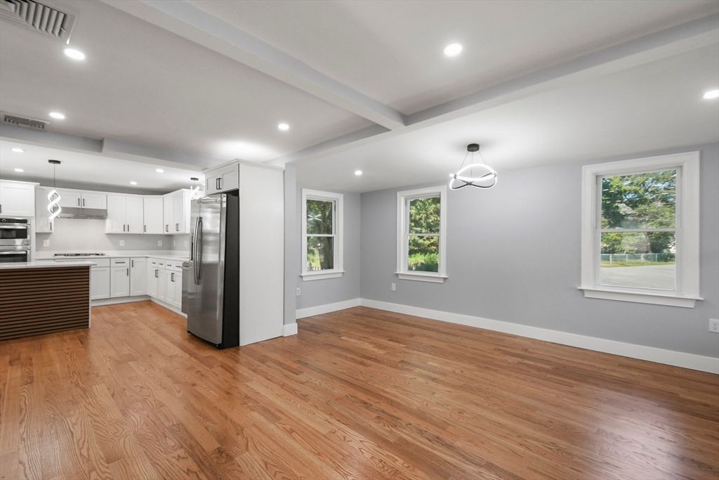 Empty room, Interior, Kitchen, Pendant Lights, Recessed Lighting, Stainless Steel Appliances, Wood Texture Flooring