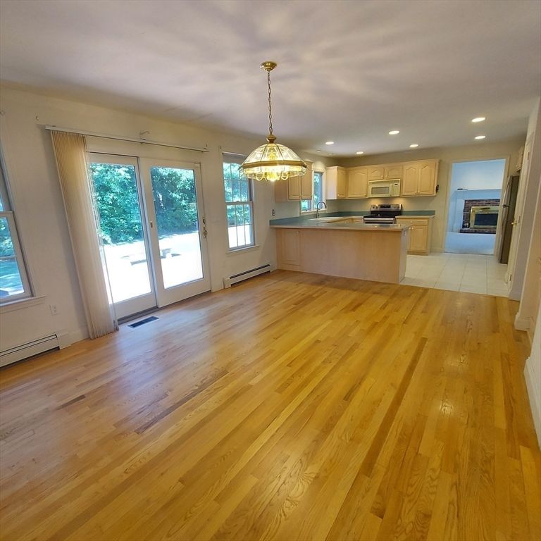 Empty room, Interior, Kitchen, Pendant Lights, Recessed Lighting, Stainless Steel Appliances, Wood Texture Flooring