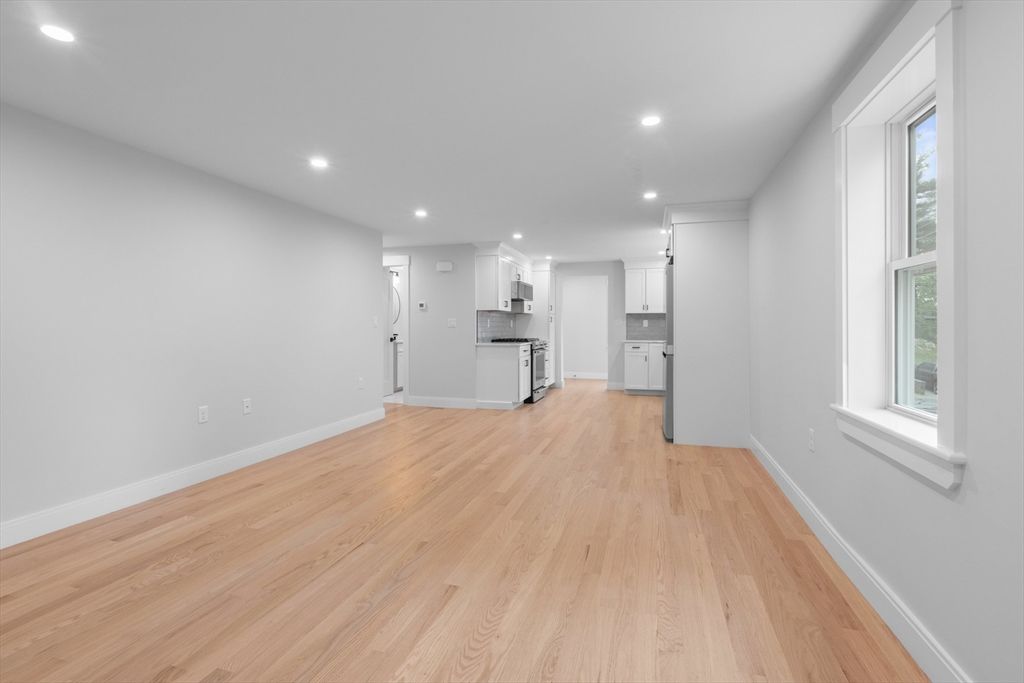 Empty room, Interior, Kitchen, Recessed Lighting, Stainless Steel Appliances, Wood Texture Flooring
