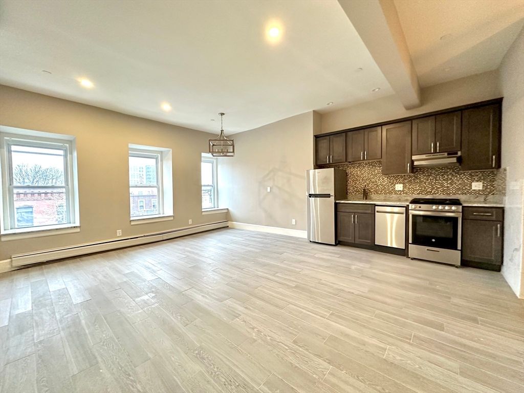 Empty room, Interior, Kitchen, Pendant Lights, Recessed Lighting, Stainless Steel Appliances, Wood Texture Flooring