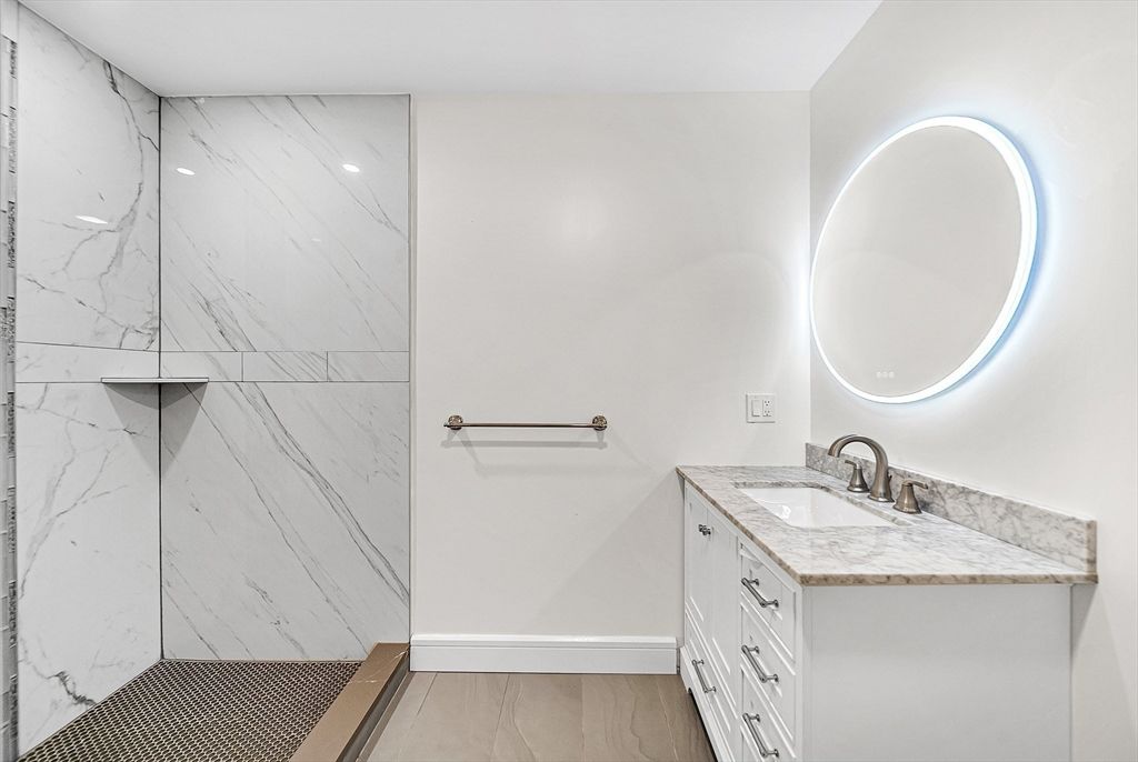 Bathroom, Dual Sink Vanities, Glass Shower, Interior, Marble Walls, Wood Texture Flooring