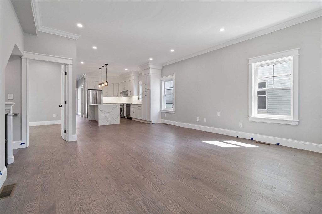 Empty room, Interior, Kitchen, Marble Walls, Pendant Lights, Recessed Lighting, Stainless Steel Appliances, Wood Texture Flooring