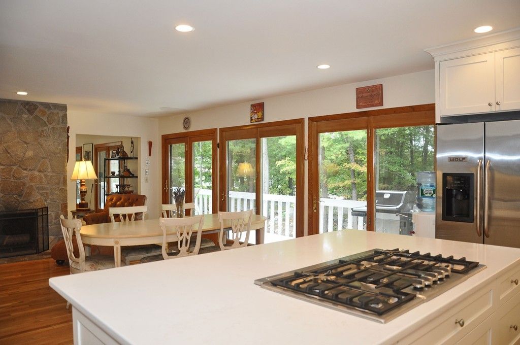 Dining room, Fireplace, Interior, Kitchen, Recessed Lighting, Stainless Steel Appliances, Stone Walls, Wood Texture Flooring