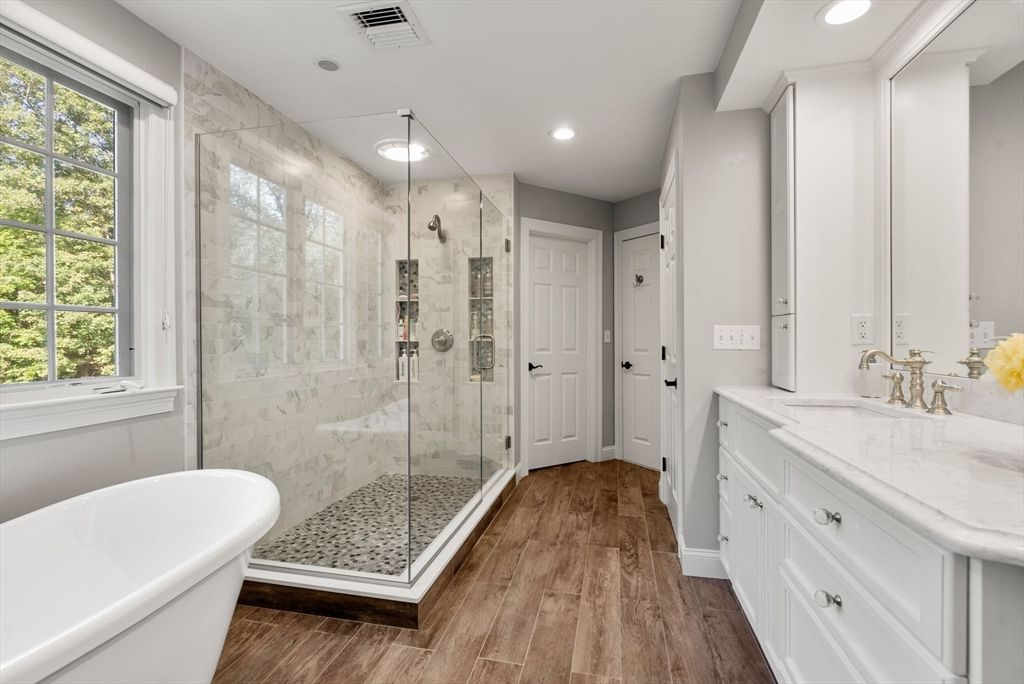 Bathroom, Free Standing Baths, Glass Shower, Interior, Marble Walls, Recessed Lighting, Wood Texture Flooring