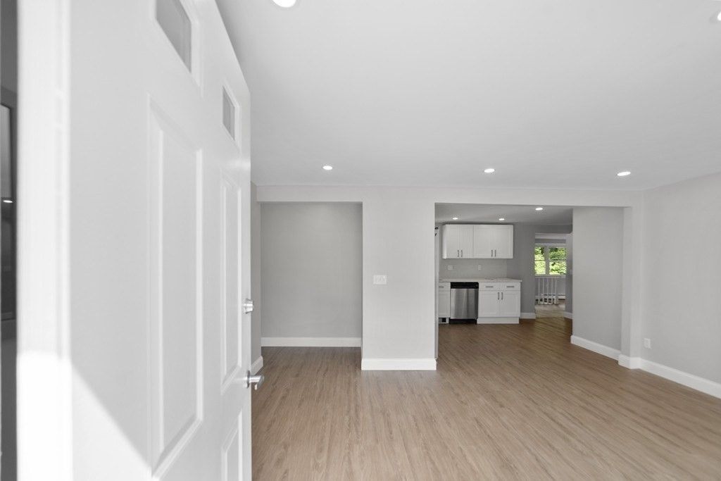 Empty room, Interior, Kitchen, Recessed Lighting, Stainless Steel Appliances, Wood Texture Flooring
