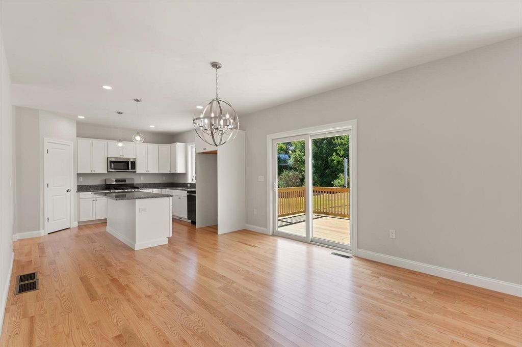 Chandelier, Empty room, Interior, Kitchen, Pendant Lights, Recessed Lighting, Stainless Steel Appliances, Wood Texture Flooring
