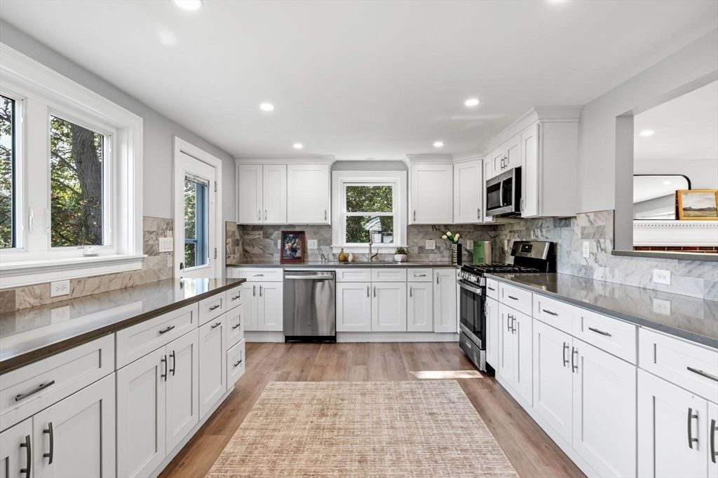 Interior, Kitchen, Marble Walls, Recessed Lighting, Stainless Steel Appliances, Wood Texture Flooring