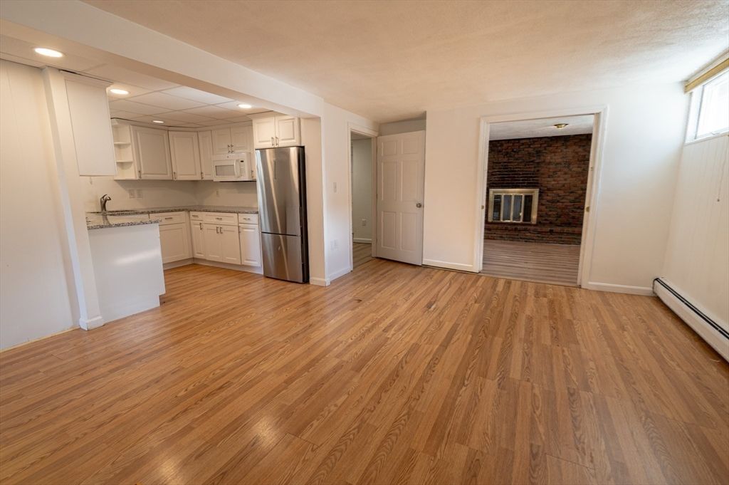 Fireplace, Interior, Kitchen, Recessed Lighting, Stainless Steel Appliances, Stone Walls, Wood Texture Flooring