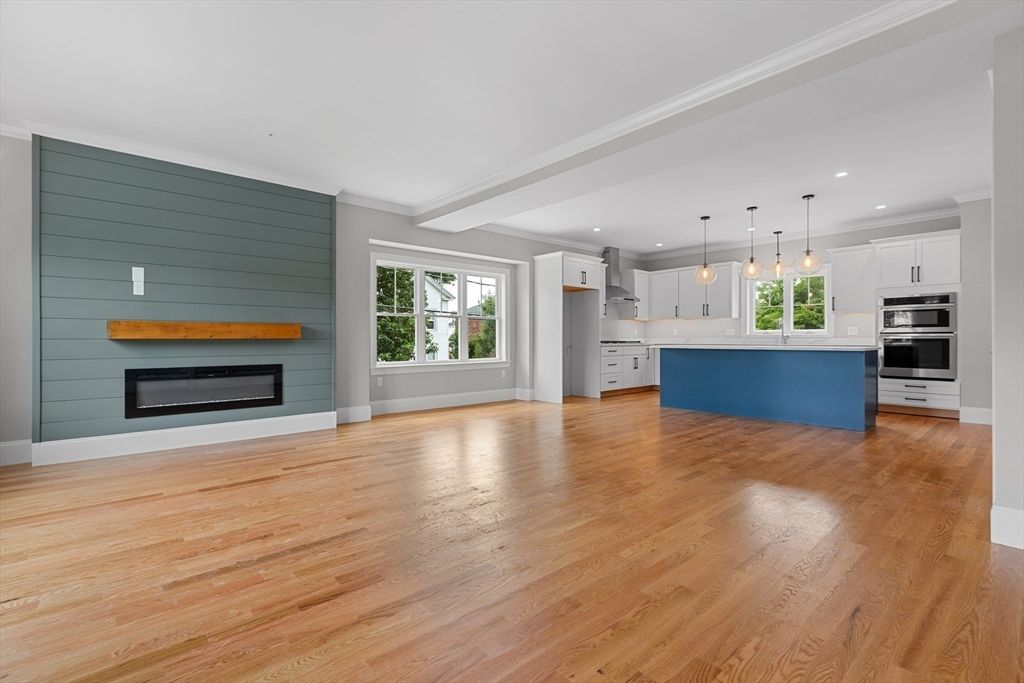 Empty room, Fireplace, Interior, Kitchen, Pendant Lights, Recessed Lighting, Stainless Steel Appliances, Wood Texture Flooring