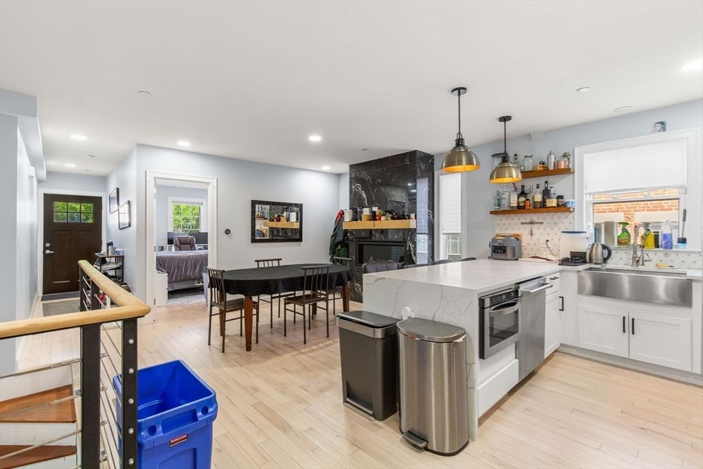 Dining room, Fireplace, Interior, Kitchen, Living room, Pendant Lights, Recessed Lighting, Stainless Steel Appliances, Wood Texture Flooring