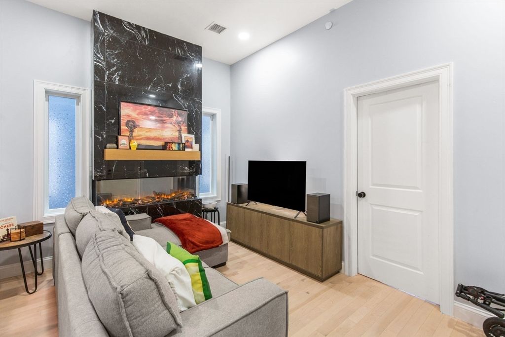 Fireplace, Interior, Living room, Marble Walls, Recessed Lighting, Wood Texture Flooring