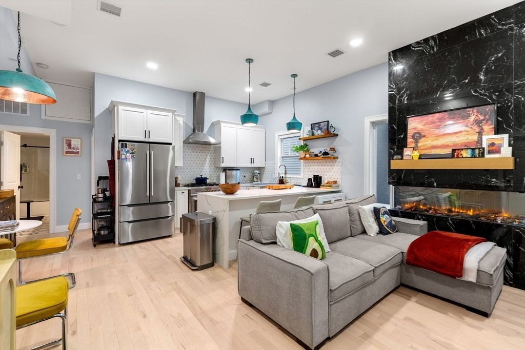 Fireplace, Interior, Kitchen, Living room, Pendant Lights, Recessed Lighting, Stainless Steel Appliances, Wood Texture Flooring