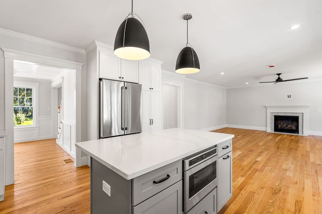 Fireplace, Interior, Kitchen, Pendant Lights, Recessed Lighting, Stainless Steel Appliances, Wood Texture Flooring
