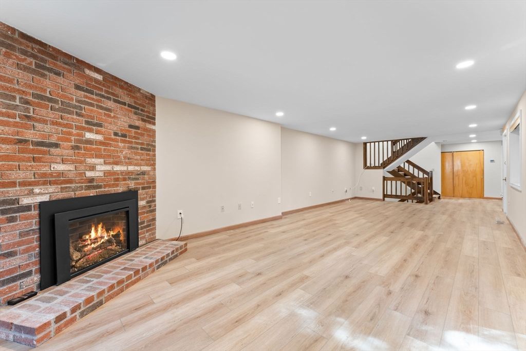 Empty room, Fireplace, Interior, Recessed Lighting, Stone Walls, Wood Texture Flooring