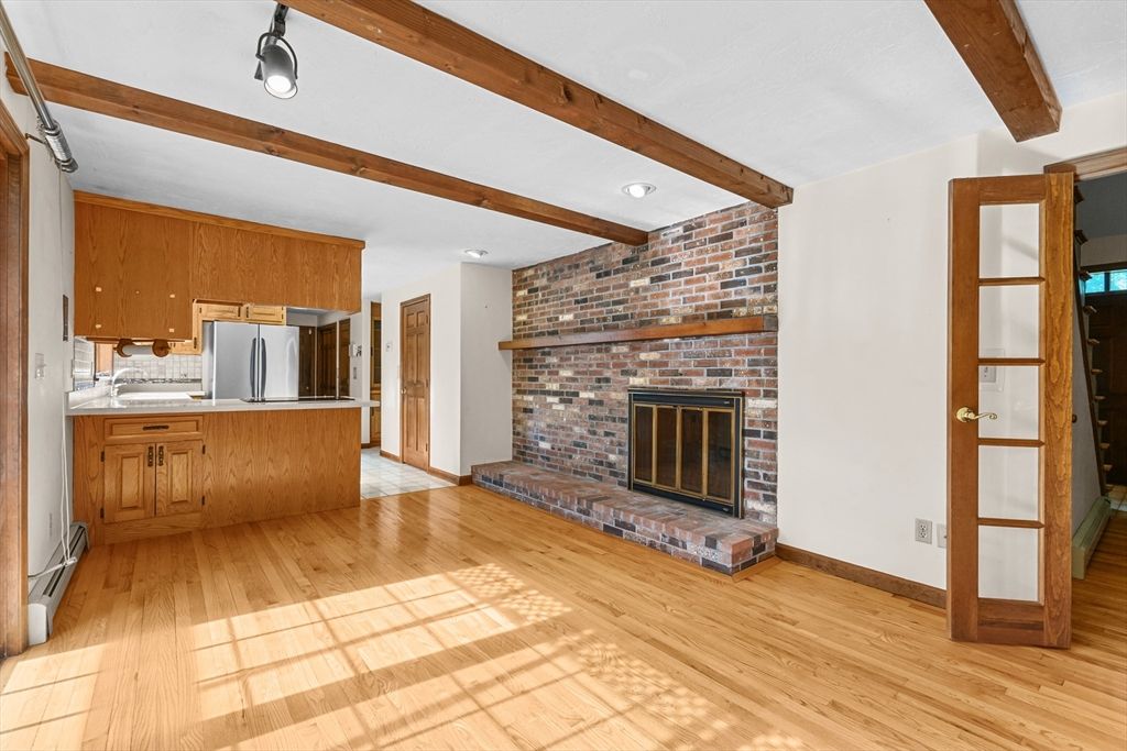 Empty room, Fireplace, Interior, Kitchen, Recessed Lighting, Stone Walls, Wooden Beams, Wood Texture Flooring