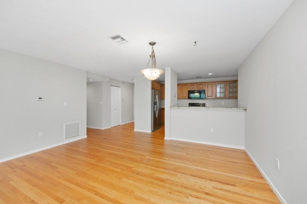 Empty room, Interior, Kitchen, Pendant Lights, Recessed Lighting, Stainless Steel Appliances, Wood Texture Flooring
