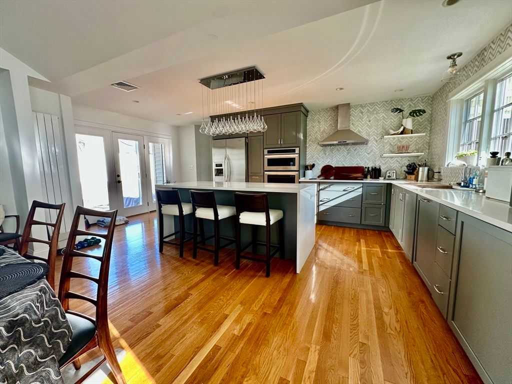 Interior, Kitchen, Pendant Lights, Recessed Lighting, Stainless Steel Appliances, Stone Walls, Wood Texture Flooring