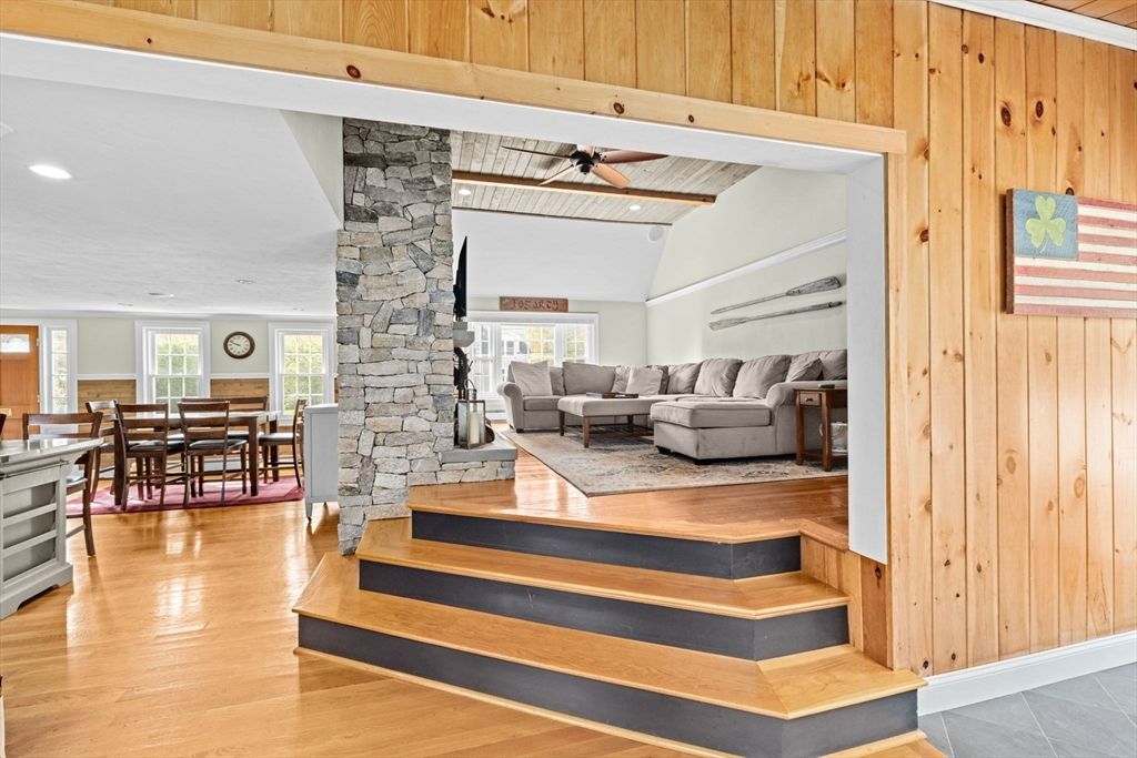 Dining room, Fireplace, Interior, Living room, Recessed Lighting, Stone Walls, Wood Texture Flooring, Wooden Walls
