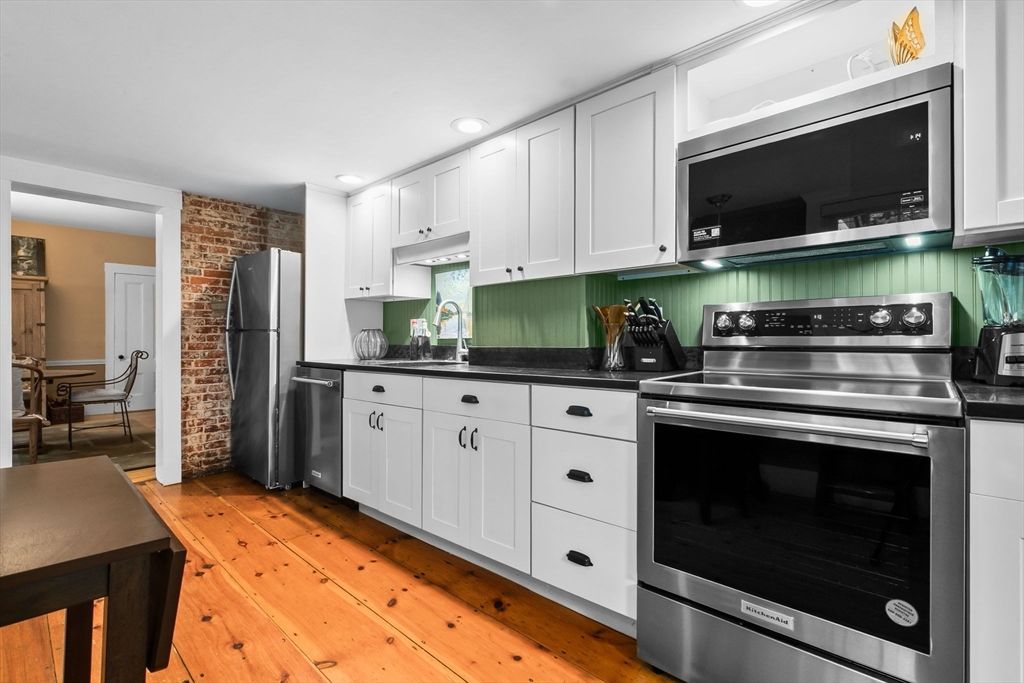 Dining room, Interior, Kitchen, Recessed Lighting, Stainless Steel Appliances, Stone Walls, Wood Texture Flooring