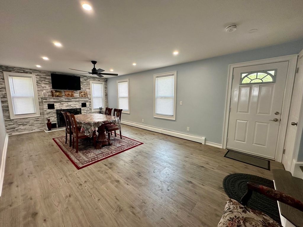 Dining room, Fireplace, Interior, Recessed Lighting, Stone Walls, Wood Texture Flooring