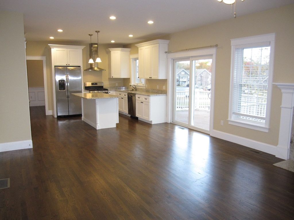 Empty room, Interior, Kitchen, Pendant Lights, Recessed Lighting, Stainless Steel Appliances, Wood Texture Flooring