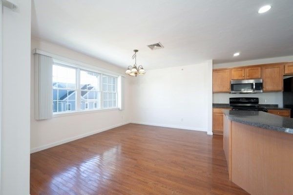 Chandelier, Empty room, Interior, Kitchen, Recessed Lighting, Stainless Steel Appliances, Wood Texture Flooring