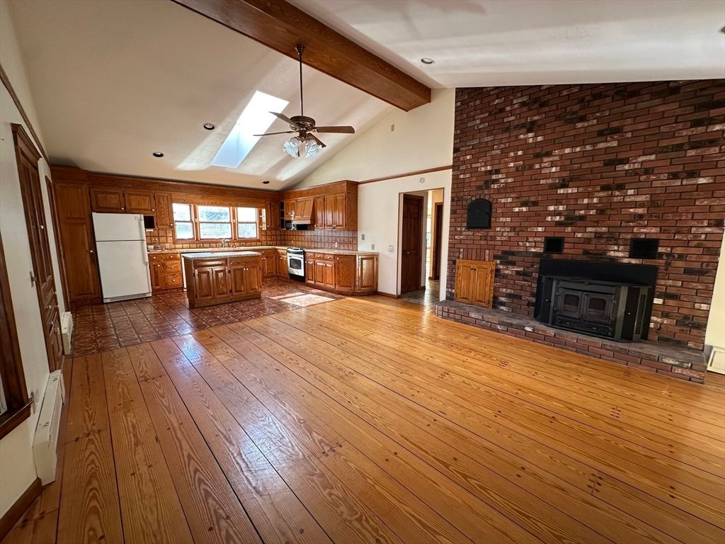Empty room, Fireplace, Interior, Kitchen, Recessed Lighting, Stone Walls, Wooden Beams, Wood Texture Flooring