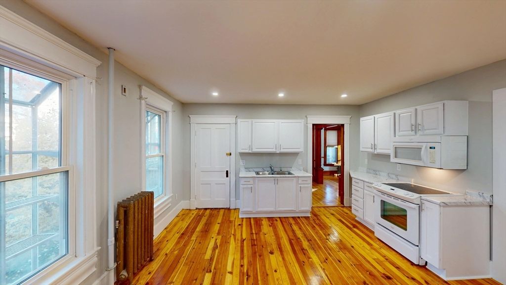Interior, Kitchen, Recessed Lighting, Washer, Wood Texture Flooring
