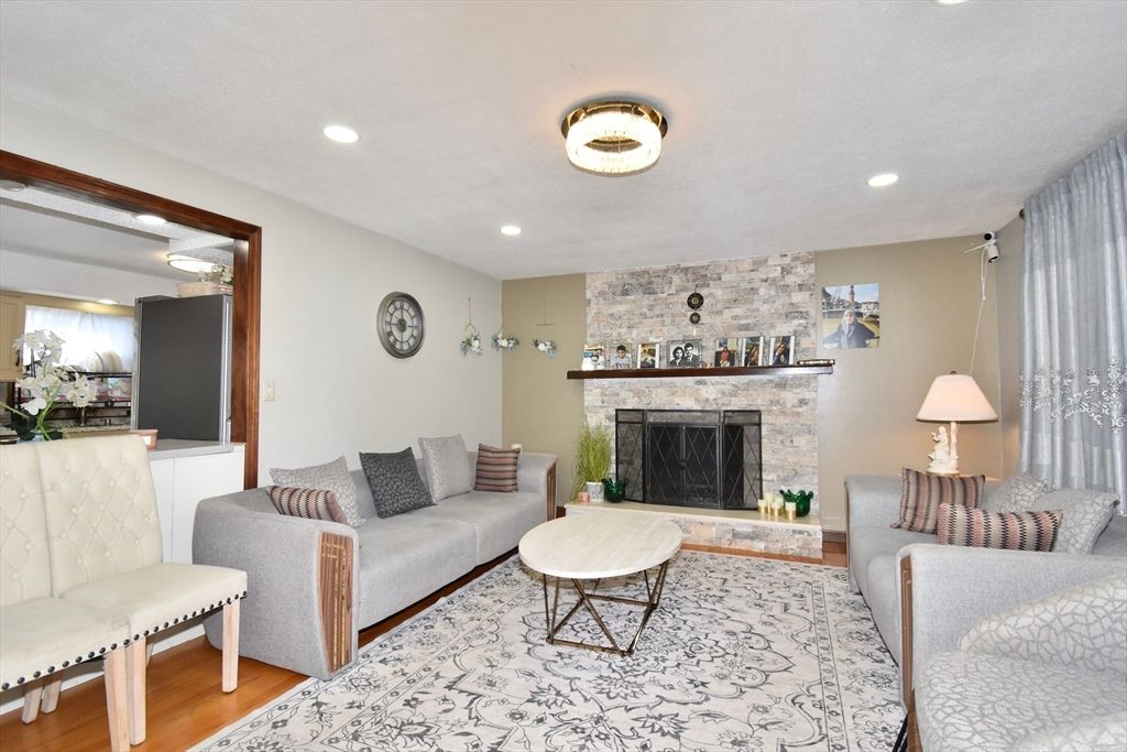 Fireplace, Interior, Living room, Recessed Lighting, Stone Walls, Wood Texture Flooring