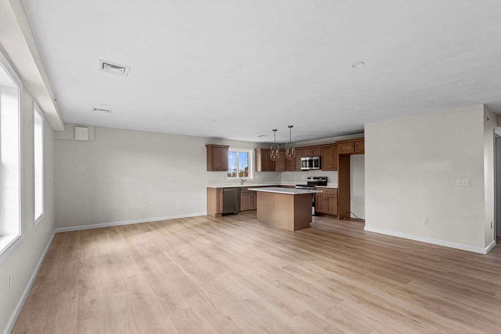 Empty room, Interior, Kitchen, Pendant Lights, Stainless Steel Appliances, Wood Texture Flooring