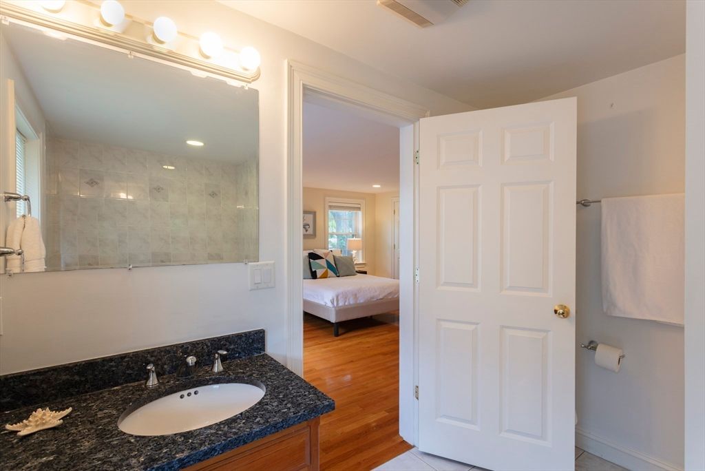 Bathroom, Bedroom, Dual Sink Vanities, Glass Shower, Interior, Marble Walls, Recessed Lighting, Wood Texture Flooring