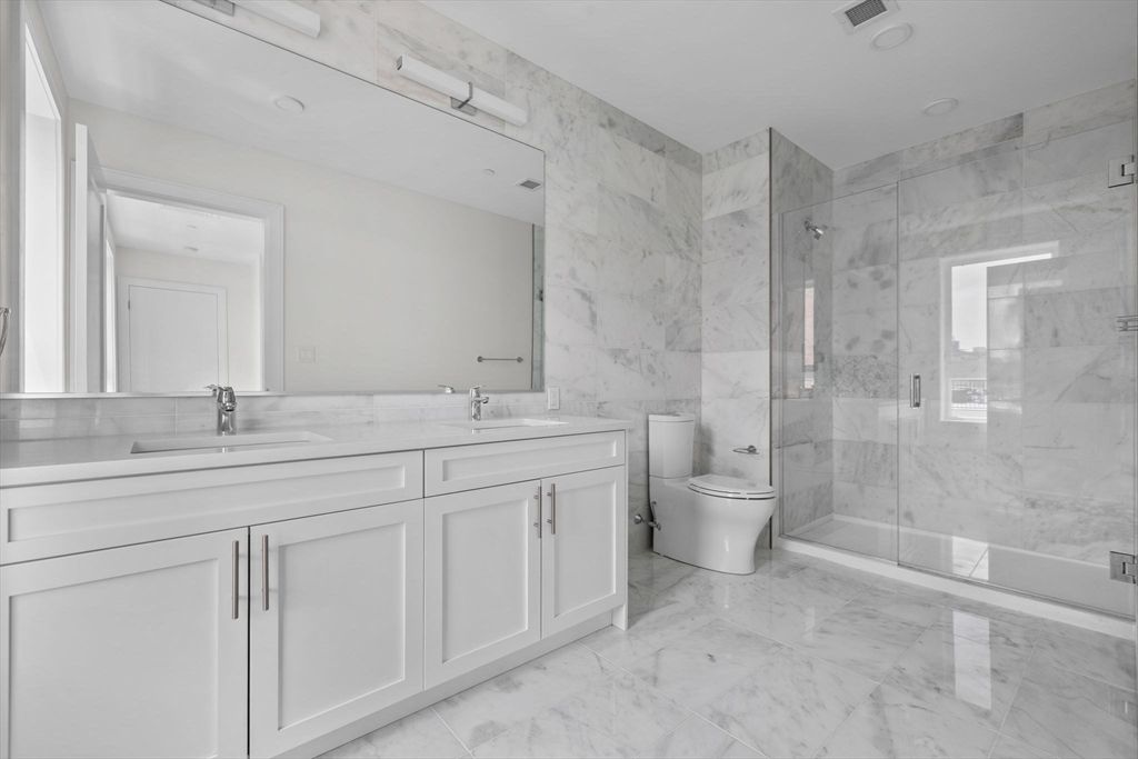 Bathroom, Dual Sink Vanities, Glass Shower, Interior, Marble, Marble Walls, Recessed Lighting
