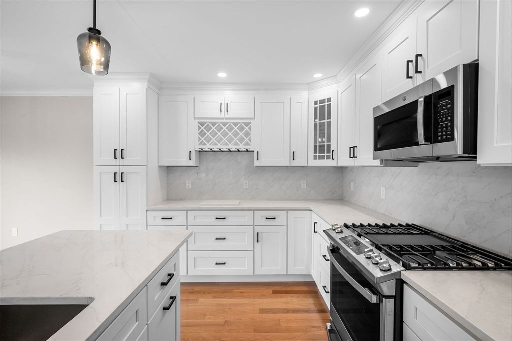 Interior, Kitchen, Marble Walls, Pendant Lights, Recessed Lighting, Stainless Steel Appliances, Wood Texture Flooring