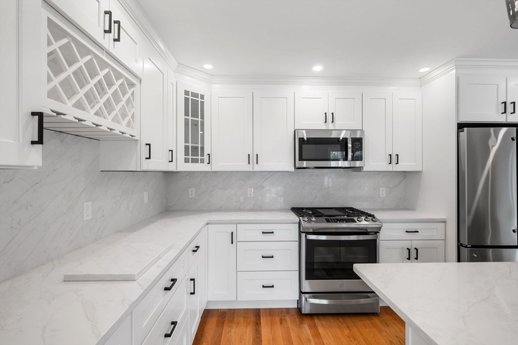 Interior, Kitchen, Marble Walls, Recessed Lighting, Stainless Steel Appliances, Wood Texture Flooring