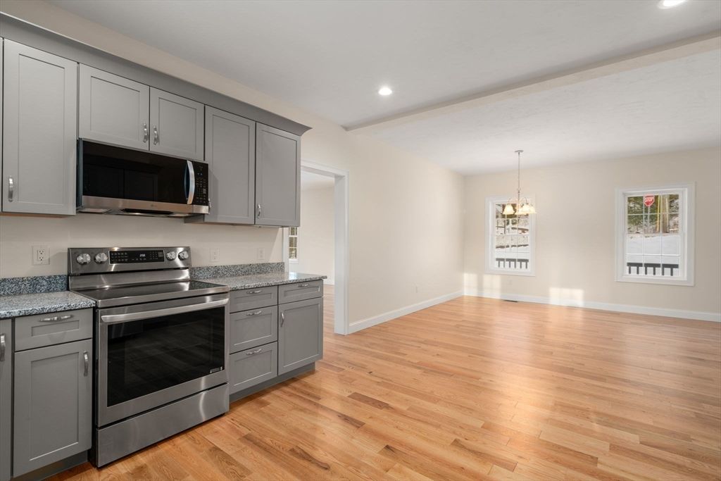 Empty room, Interior, Kitchen, Pendant Lights, Recessed Lighting, Stainless Steel Appliances, Wood Texture Flooring